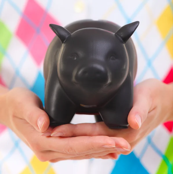 Woman holding the piggy bank in her hands — Stock Photo, Image