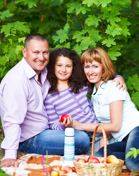 Happy young family with daughter on picnic — Stock Photo, Image