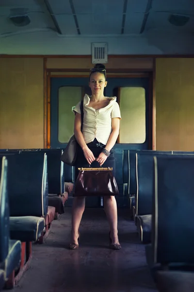 Woman with a suitcase walking in wagon of the retro train — Stock Photo, Image