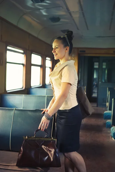 Woman with a suitcase walking in the retro train — Stock Photo, Image