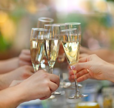 People holding glasses of champagne making a toast clipart