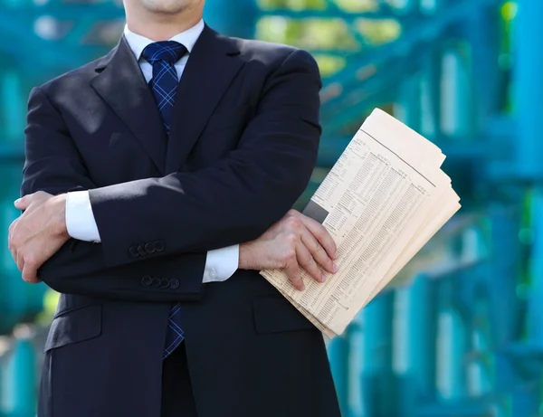 Close up of the hands of the businessman with a newspaper — Stock Photo, Image