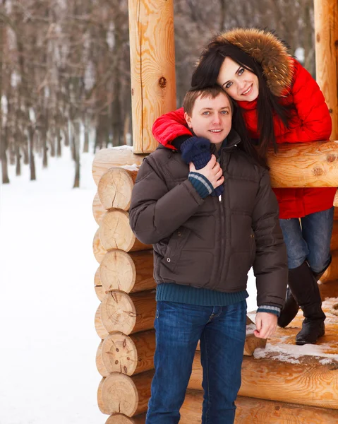 Happy young couple having fun in the winter park — Stock Photo, Image