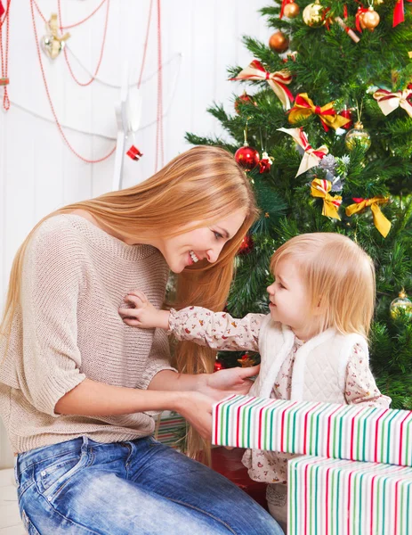 Mãe com sua filhinha debaixo da árvore de Natal — Fotografia de Stock