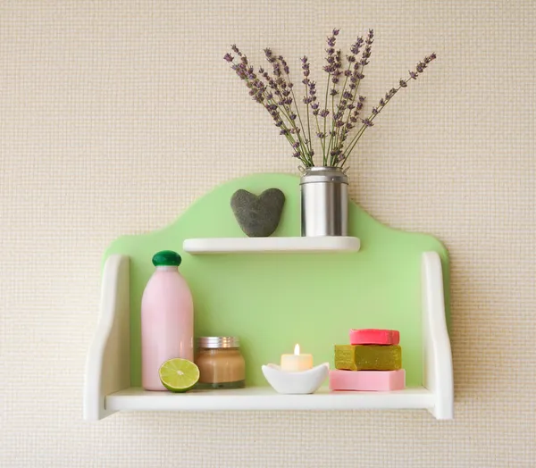 Decorative shelf with lavender flowers in vase and cosmetics — Stock Photo, Image