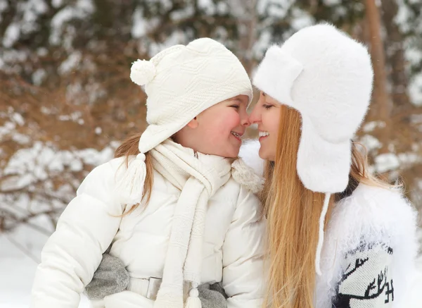 Young blond mother takes care of her daughter outdoors — Stock Photo, Image