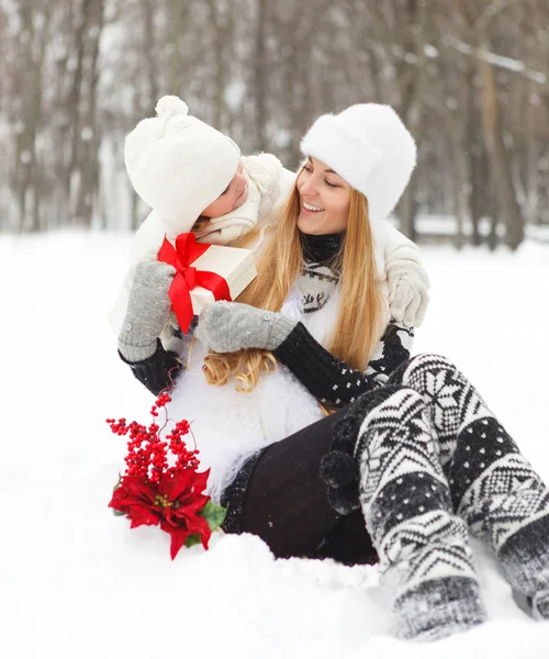 Happy young mother with daughter with present — Stock Photo, Image