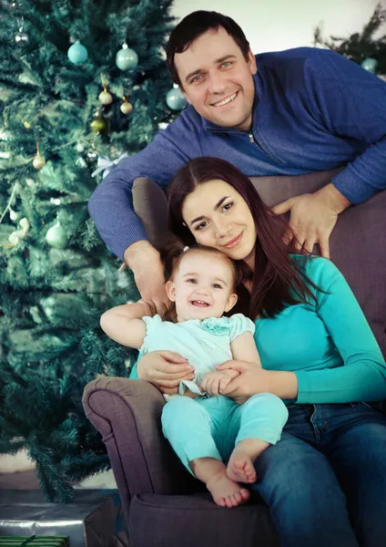 Happy family near the Christmas tree — Stock Photo, Image