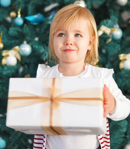 Adorable little girl with Christmas present — Stock Photo, Image
