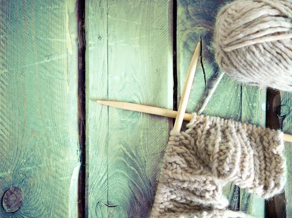 Colorful ball of yarn and knitting on a wooden table — Stock Photo, Image