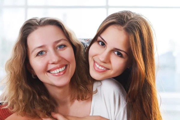 Porträt einer Mutter und einer Teenager-Tochter, die sich eng umarmen — Stockfoto