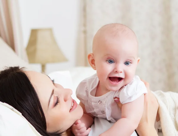 Gelukkig lachend moeder met zes maanden oude babymeisje — Stockfoto