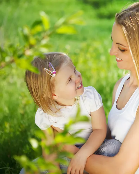 Happy mother and her little daughter in the spring Stock Photo