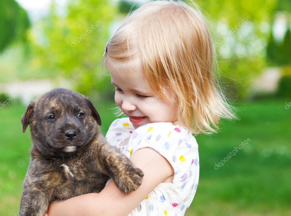 Cute little girl hugging dog puppy — Stock Photo © dasha11 #40018717