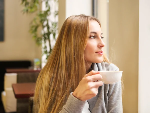 Woman drinking tea in cafe Stock Photo