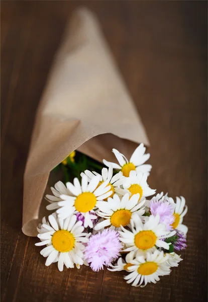 Невеликий букет з польових квітів на сільському столі — стокове фото