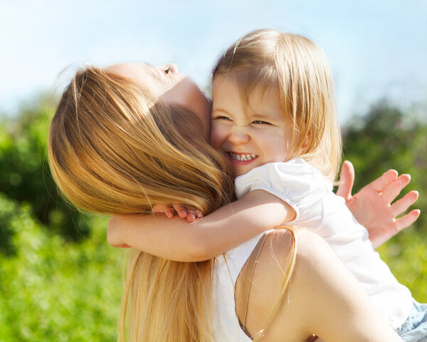 Mother and her little daughter in the spring day