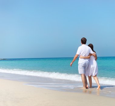 Kumsalda yürüyen genç mutlu çift