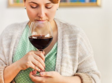 Portrait of young wiman drinking red wine with eyes closed clipart