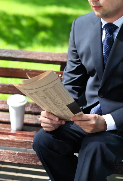 Närbild på händerna av affärsmannen med en tidning — Stockfoto