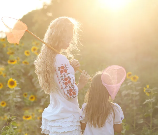 Fröhliche Mutter und ihre Tochter am Sommerabend — Stockfoto