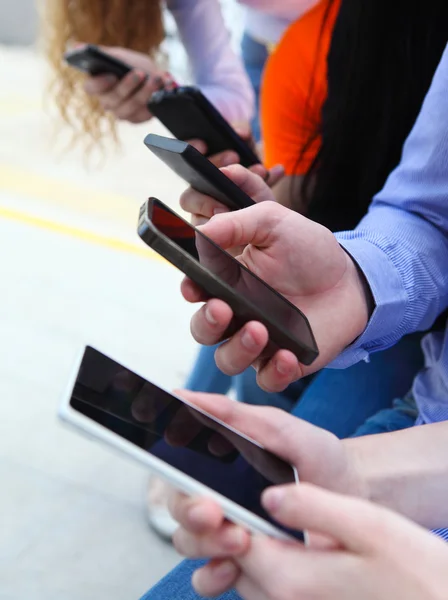 Groep een studenten chatten met hun smartphones — Stockfoto