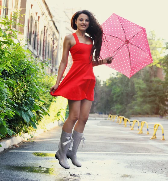 Portrait of beautiful young girl with umbrella under rain — Stock Photo, Image