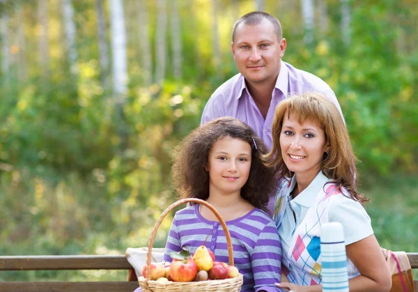 Happy family with daughter on autumn picnic — Stock Photo, Image