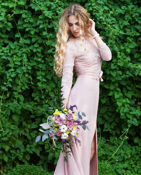 Braut hält den Hochzeitsstrauß mit saftigen Blumen — Stockfoto