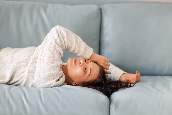Portrait Relaxed Positive Young Brunette Woman Lying Soft Blue Sofa — 스톡 사진