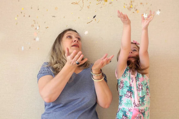 Enjoying Parenting Happy Mother Small Daughter Throwing Confetti Stars Air — 스톡 사진