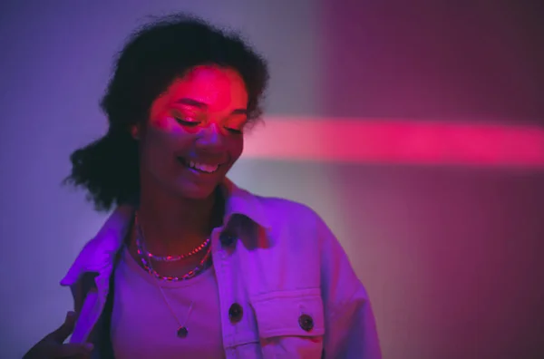 Genç Mutlu Afro Amerikalı Kadın Stüdyoda Neon Işığın Altında Duruyor — Stok fotoğraf