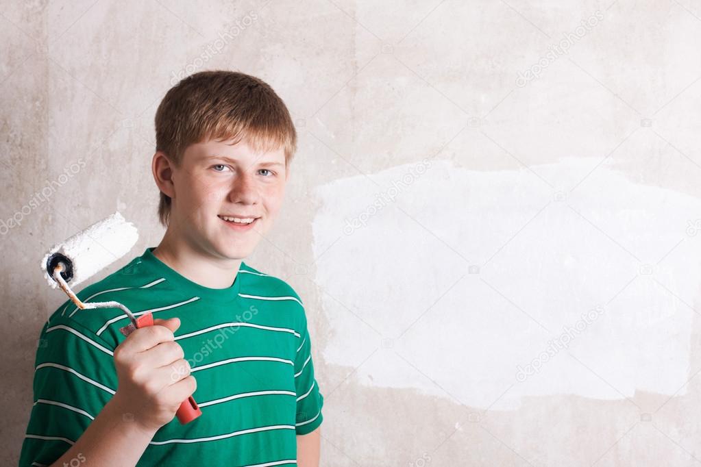 Teenager painting the wall