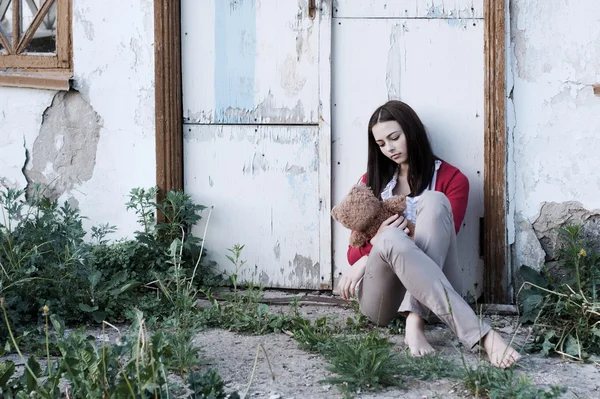 Teenage girls with toy on background old wall — Stock Photo, Image