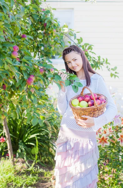 Hermosa chica con manzana en el jardín — Foto de Stock