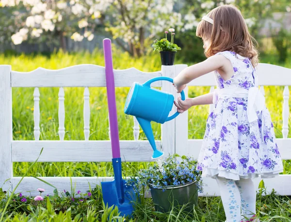 Ragazza irrigazione fiori primaverili — Foto Stock