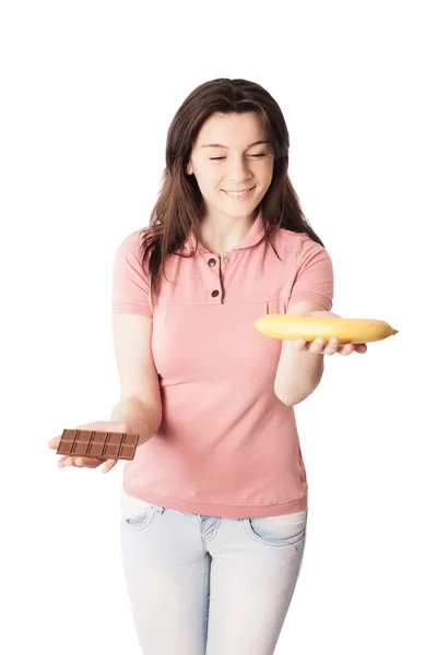 Fille avec chocolat et banane isolé sur blanc — Photo