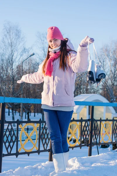 Beautiful brunette girl with ice skate outdoor — Stock Photo, Image