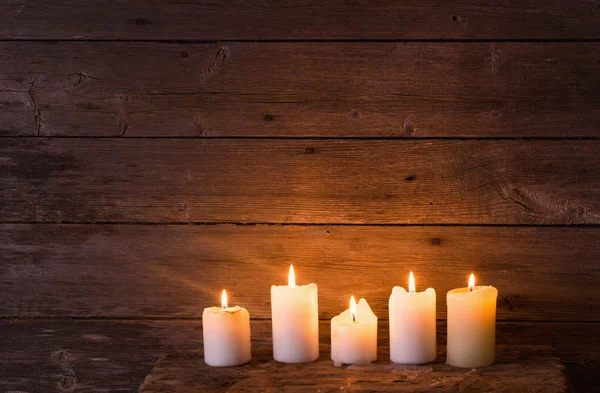 Candles on old wooden background — Stock Photo, Image