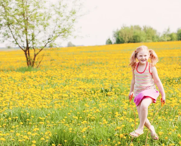 Girl jumping over a skipping rope — Stock Photo, Image