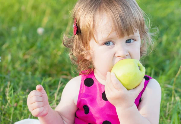 Klein meisje houdt groene appel — Stockfoto