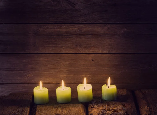 Green candles on old wooden background — Stock Photo, Image