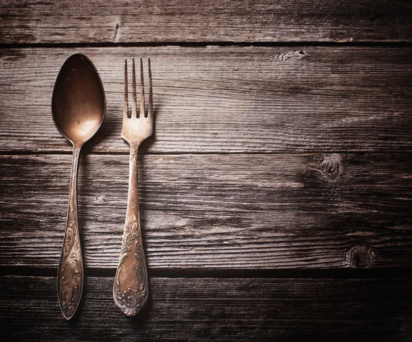 Old fork and spoon on wooden background — Stock Photo, Image