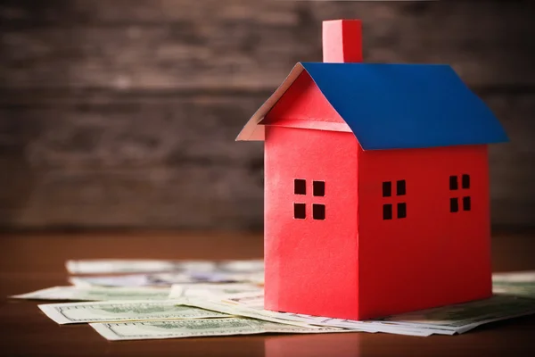 House from the paper and money on wooden background — Stock Photo, Image