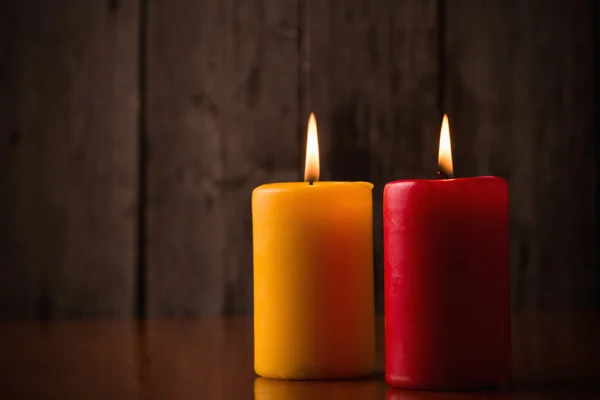 Candles on old wooden background — Stock Photo, Image
