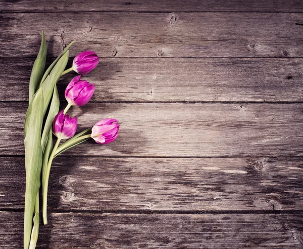 Tulips on wooden background — Stock Photo, Image