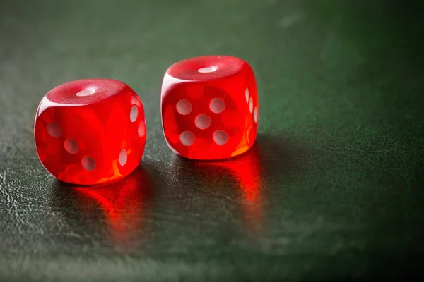 Пара брошенных красных кубиков на зеленый стол Стоковое Изображение