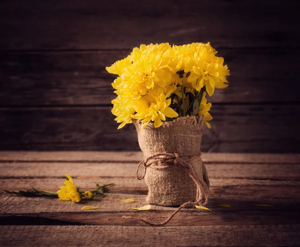 Yellow flowers on wooden background — Stock Photo, Image