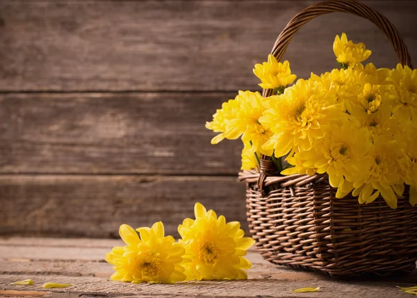 Flores en cesta sobre fondo de madera — Foto de Stock