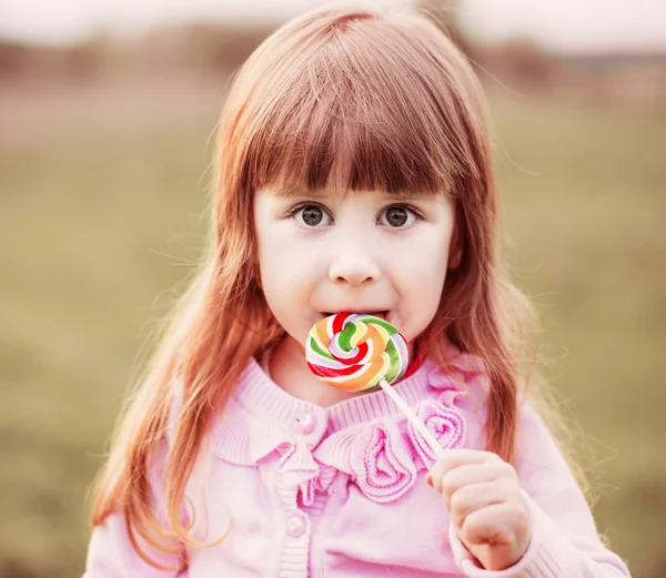 Küçük kız lolipop tutuyor. — Stok fotoğraf